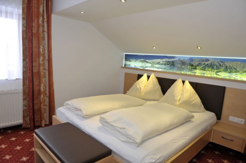 Schlafzimmer mit Teppichboden und indirekter Beleuchtung
